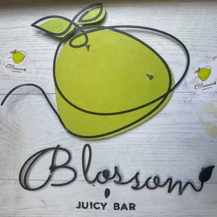 a lemon on a wooden sign