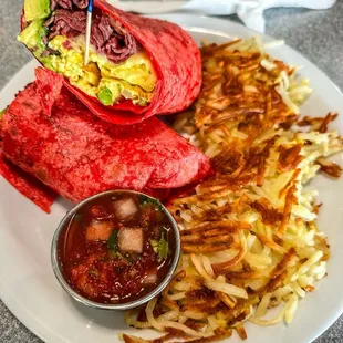 Pastrami wrap with/hashbrowns, salsa.