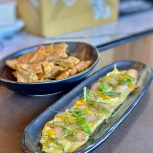 SCALLOP SASHIMI - Japanese scallops, yuzu avocado vinaigrette, herbs oil, frisée, fennel, orange, fried wonton.