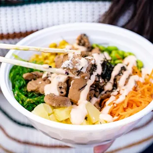 a woman holding a bowl of food