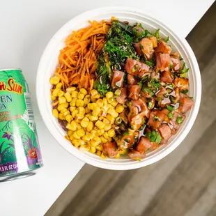 a bowl of food and a can of soda