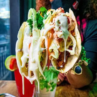 a woman wearing a face mask and holding a taco