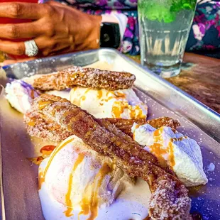 a plate of food with ice cream and caramel sauce