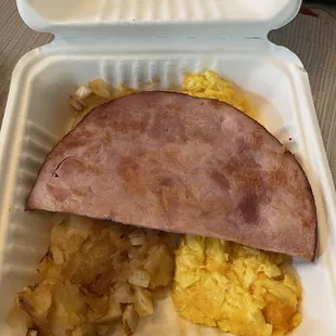 French toast platter with scrambled eggs, ham, and home fries