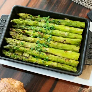 a pan of asparagus and a loaf of bread