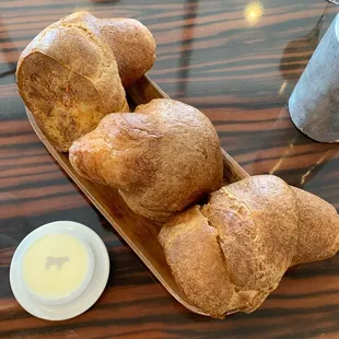 a basket of bread and butter on a table