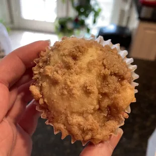 a hand holding a muffin