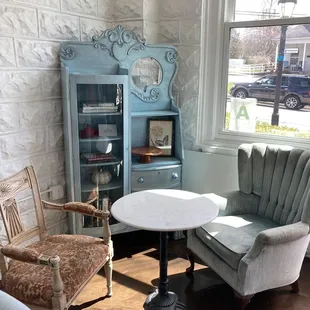 two chairs and a table in the corner of a room