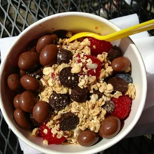 Pomegranate/Raspberry frozen yogurt topped with strawberries, Marion berries, blueberries, chocolate and granola. Yum.