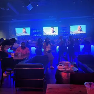 a group of people sitting at a bar