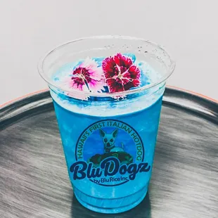 a blue drink with flowers in it