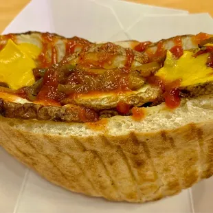 Single Hot Dog with Sautéed Onions. thinly sliced onions, bell peppers, ketchup and mustard, in a pita bread.