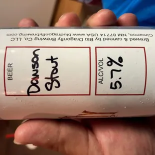 a hand holding a can