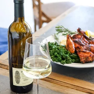 a plate of meat and a glass of wine