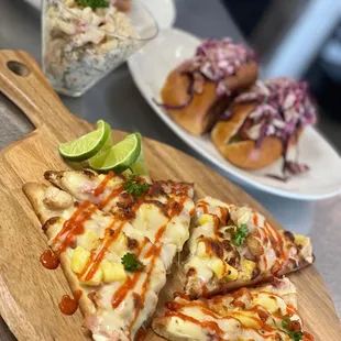 a wooden cutting board with slices of pizza on it