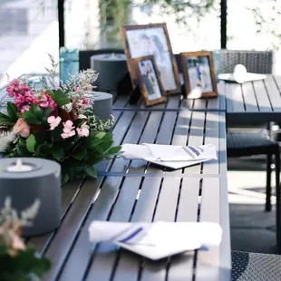 a table with flowers and a picture frame