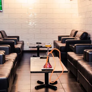 a hookah lounge with couches and a television