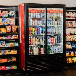 a refrigerated area with drinks and snacks