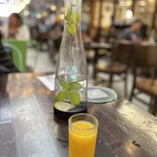 Complimentary ginger orange shot and mint water.