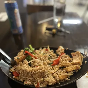 a plate of fried rice with chicken and vegetables