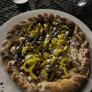 a white plate with a pizza on it