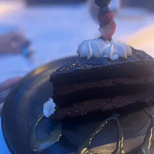 a piece of chocolate cake with whipped cream