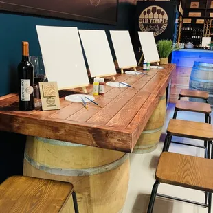 a wine tasting area with wine barrels and stools