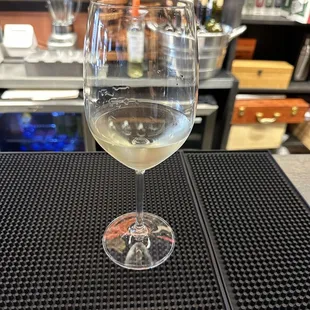 a glass of wine on a bar