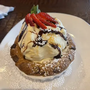 a desert topped with ice cream and strawberries