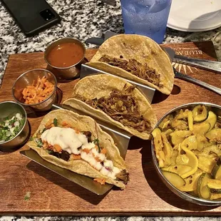 a variety of tacoss on a cutting board