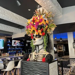 a statue of a woman with a flower crown on her head