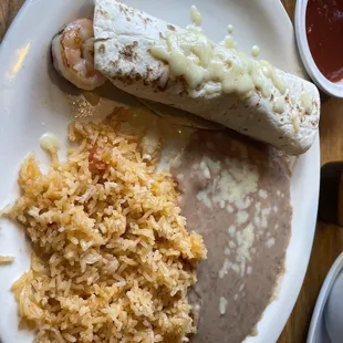 The shrimp that is sticking out of the burrito was not deveined.
