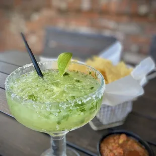 a margarita and chips on a table
