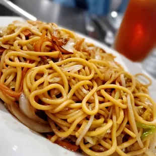 a plate of noodles with meat and vegetables
