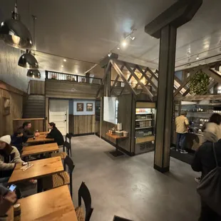 people sitting at tables in a restaurant