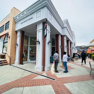people walking in front of a store