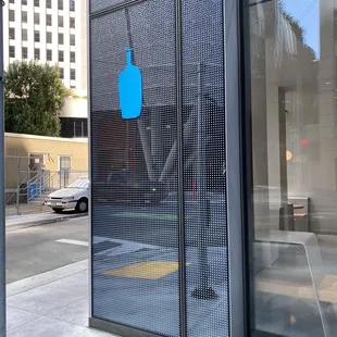 a blue bottle on the side of a building