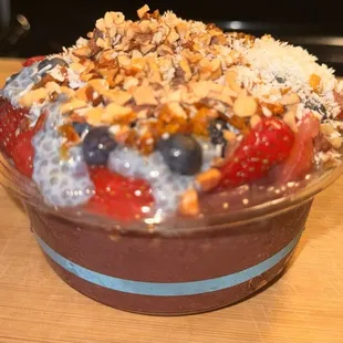 Acai, hemp granola, blue chia pudding, blueberries, strawberries, almonds, organic, coconut, apple honey, and dried mango &amp; peaches.