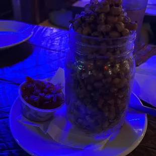 a glass jar filled with nuts on a table
