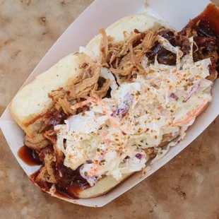 Pulled Pork on Kings Hawaiian rolls, topped with sweet and tangy BBQ sauce and our homemade pineapple coleslaw!