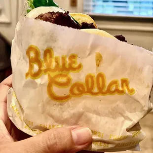 a hand holding a burrito