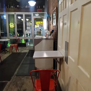 an empty restaurant with red chairs