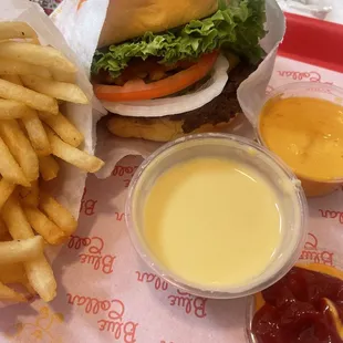 Cheeseburger meal with cheese on the side and Boom Boom special sauce