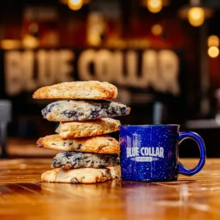 a stack of cookies and a blue mug