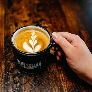 a person holding a cup of coffee
