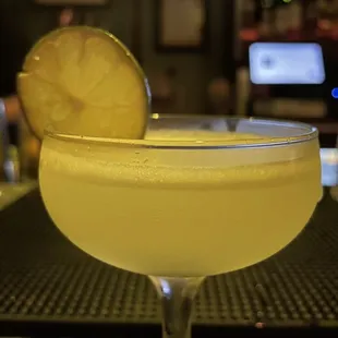 a glass of lemonade with a slice of lemon