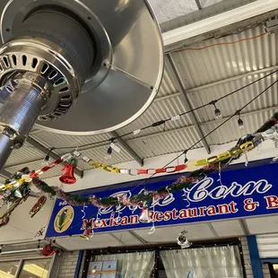 a restaurant sign and a large fan