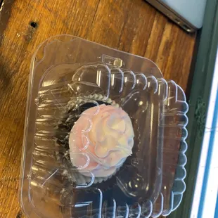 a cupcake in a plastic container
