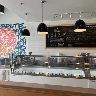 a counter with a chalkboard on the wall