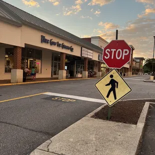 a stop sign and pedestrian crossing sign